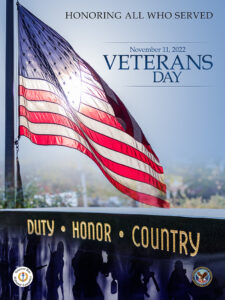 The 2022 theme for Veterans Day is “Honor.” The official poster features the American flag along with a marker that reads Duty, Honor, Country. 