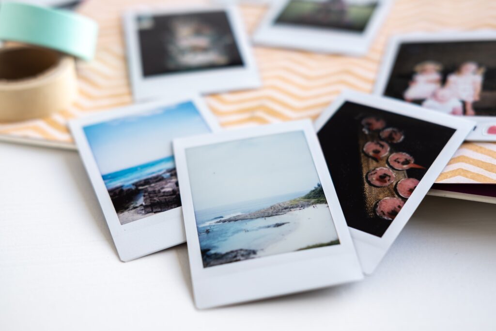 Polaroid images line a photo album.